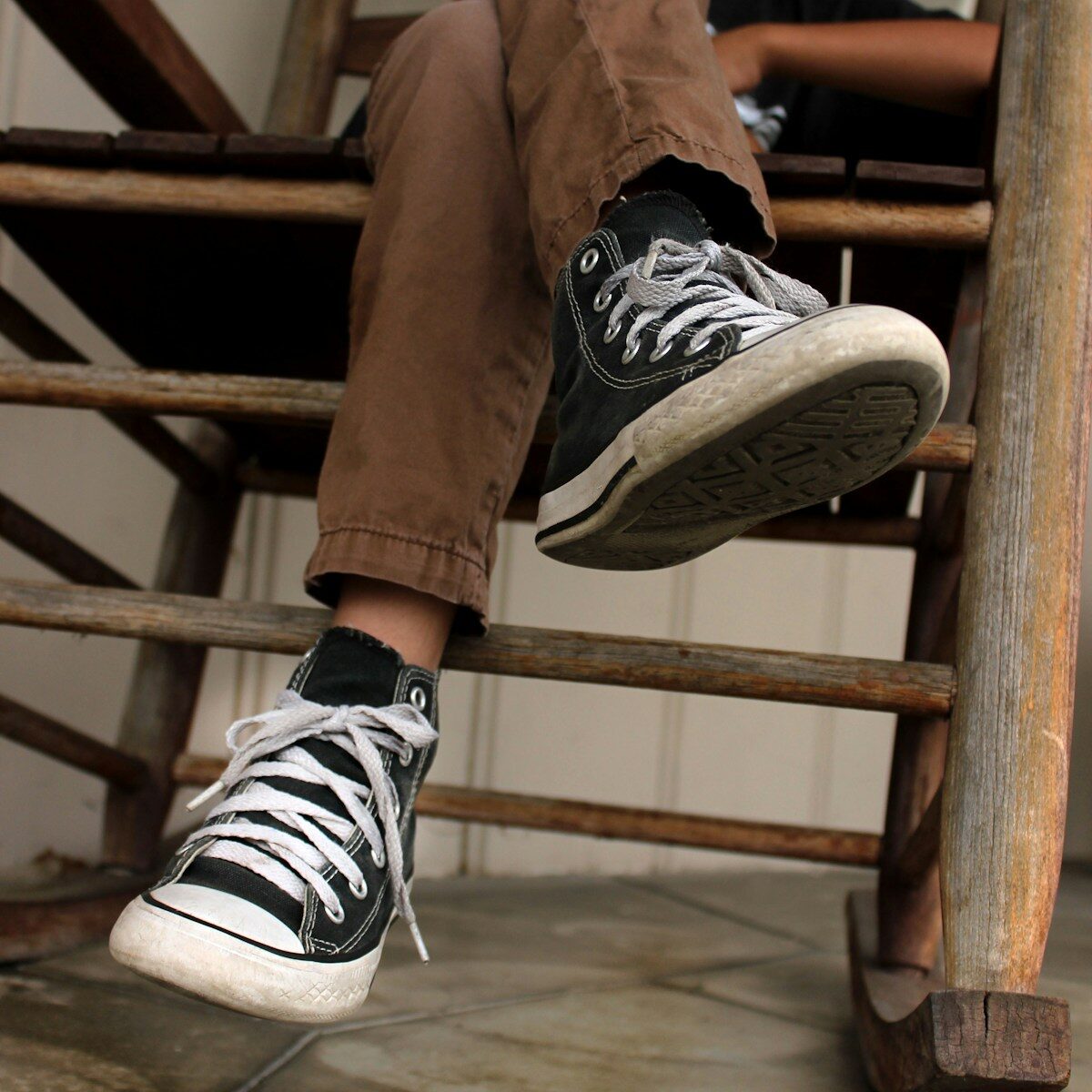 A person is sitting on a wooden step