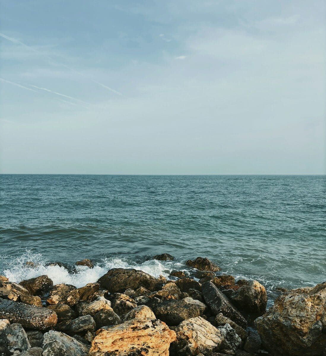 The ocean meets the rocky shoreline.